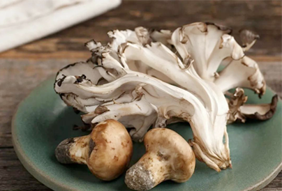 Dancer among mushrooms, delicacies on the table
